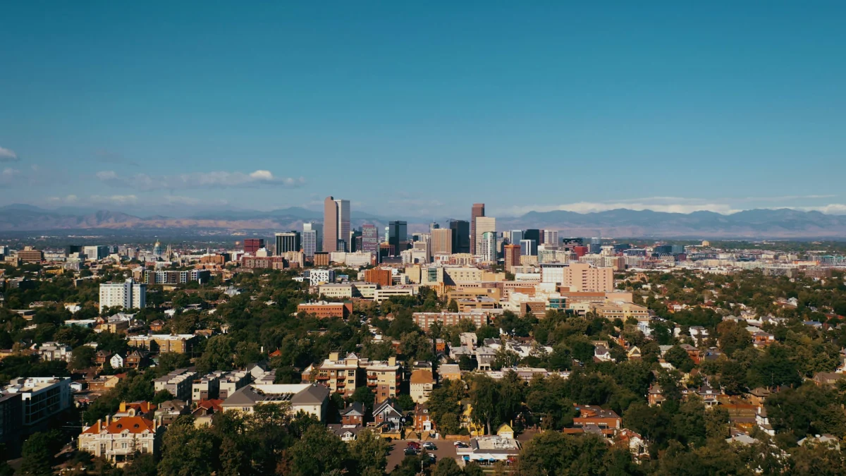 Downtown Denver skyline with the Rocky Mountains in the distance on a clear summer day