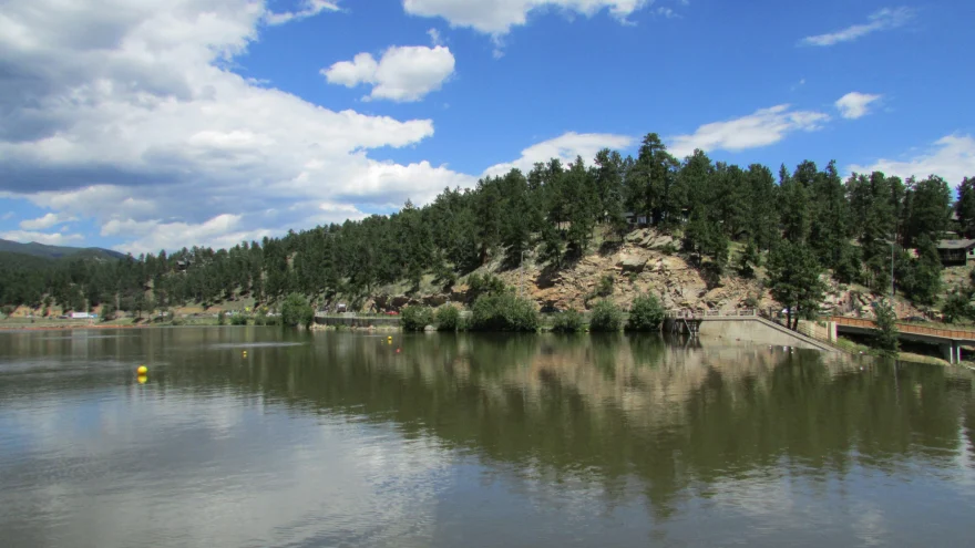 Evergreen Lake and wooded foothills in Evergreen, Colorado